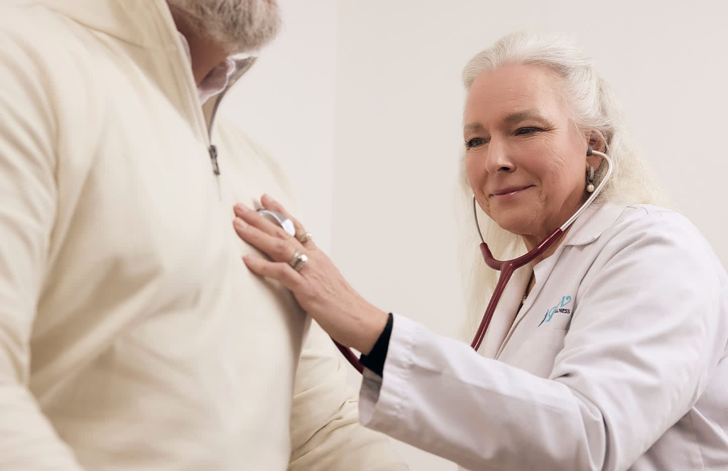 Doctor listening to patients heartbeat with stethoscope