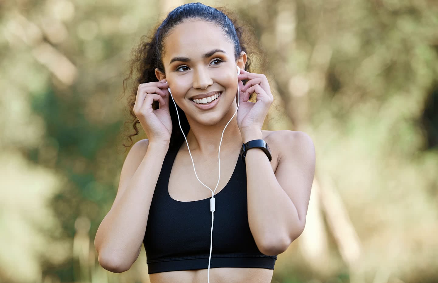female smiling with headphones on