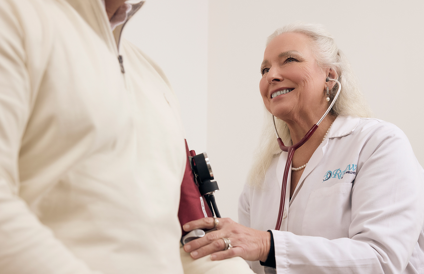 Doctor listens to patient's heart with stethoscope