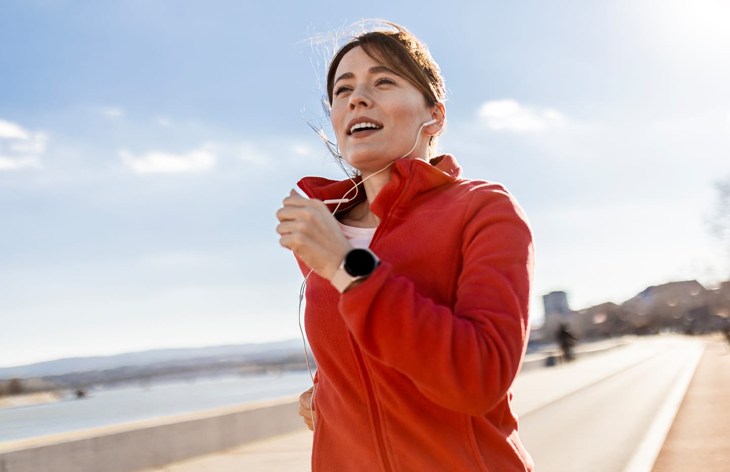female running with headphone in her ears