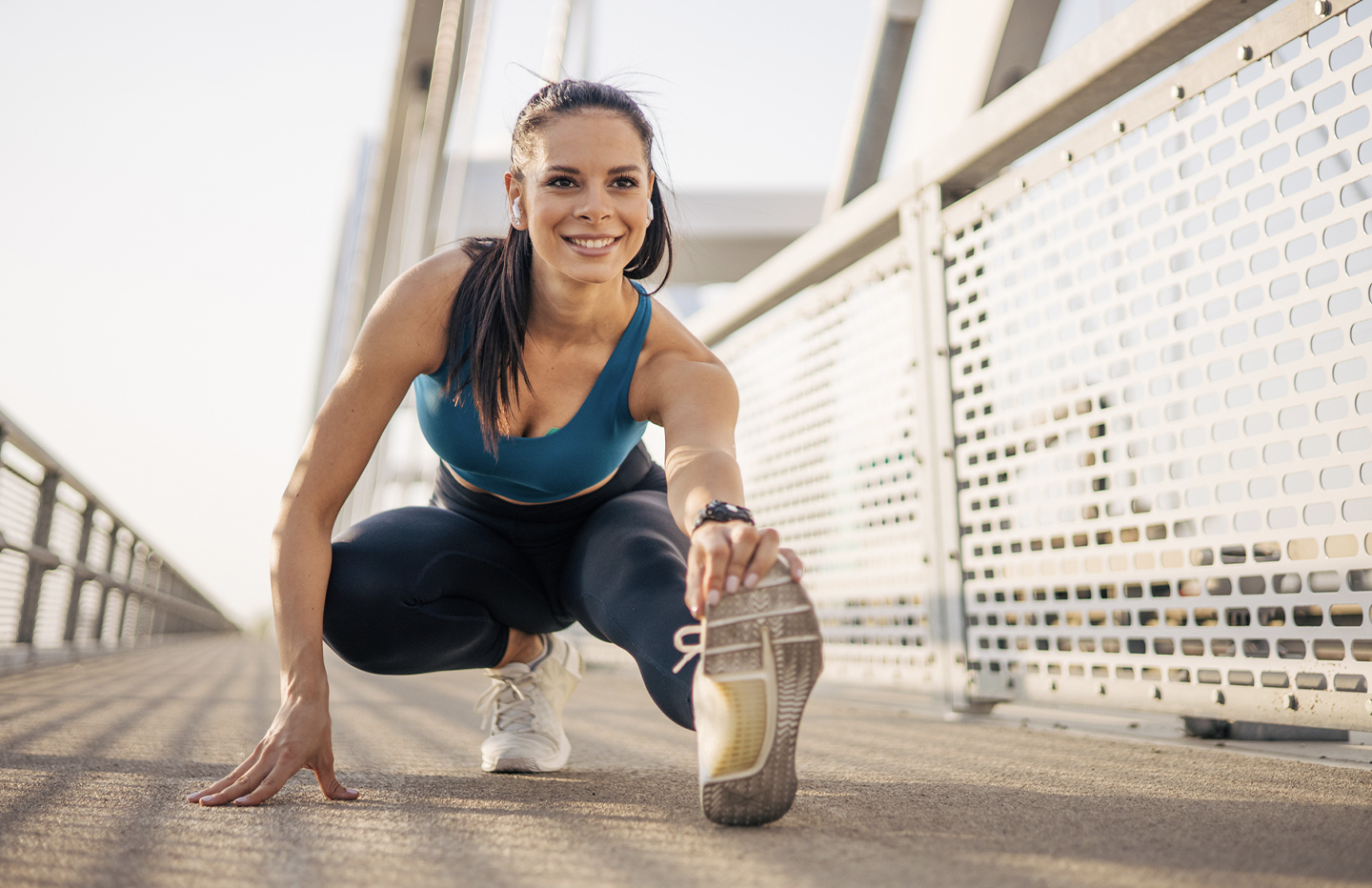 Woman stretching outside and smiling
