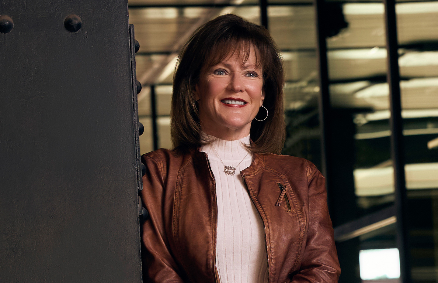 Woman leaning against wall smiling