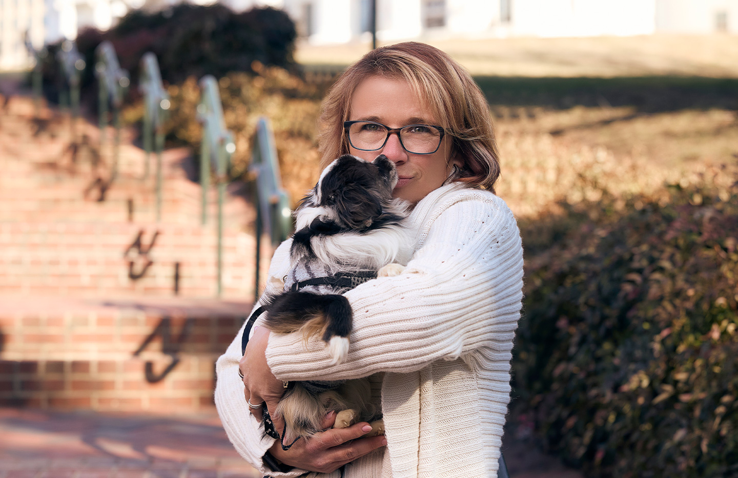 Woman kissing dog