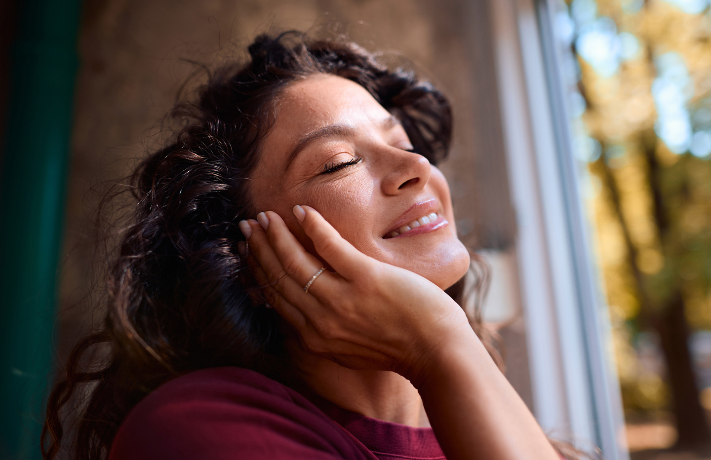 Woman smiling with her hand on her face