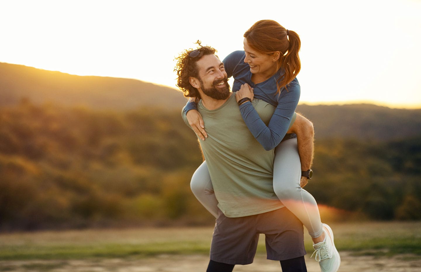 Man with woman on his back smiling