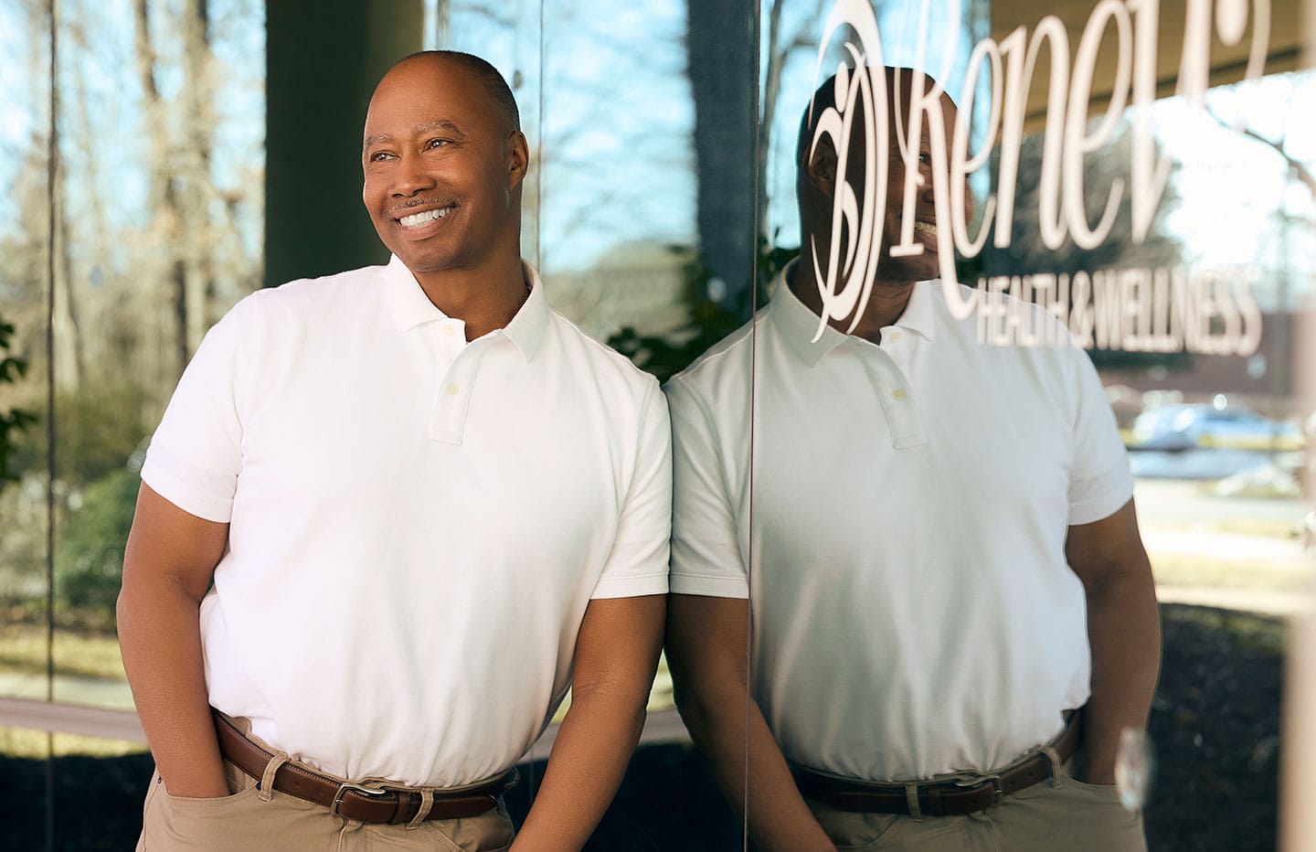 Man leaning on wall smiling