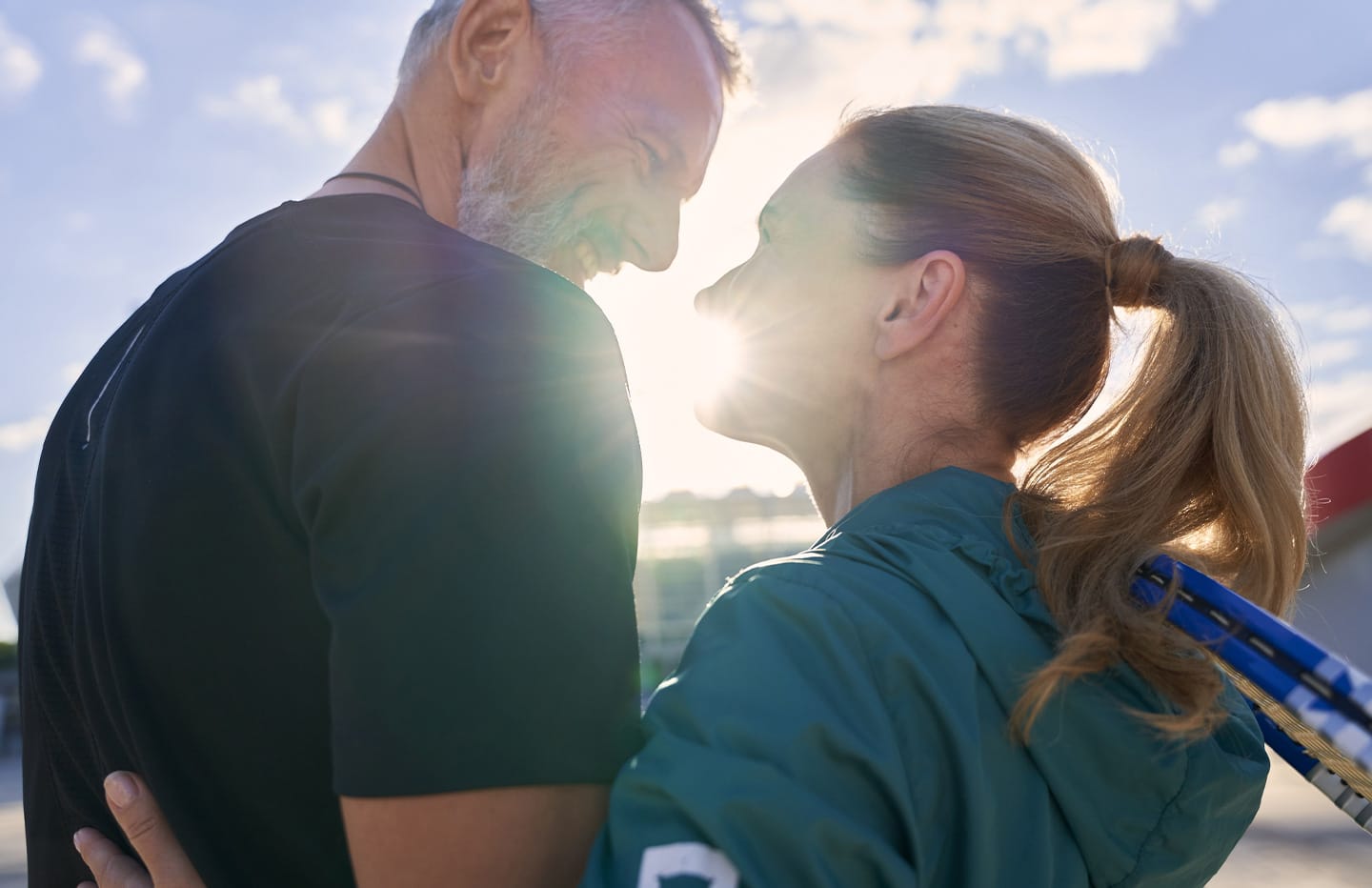 Man and woman looking at eachother and smiling in the sun