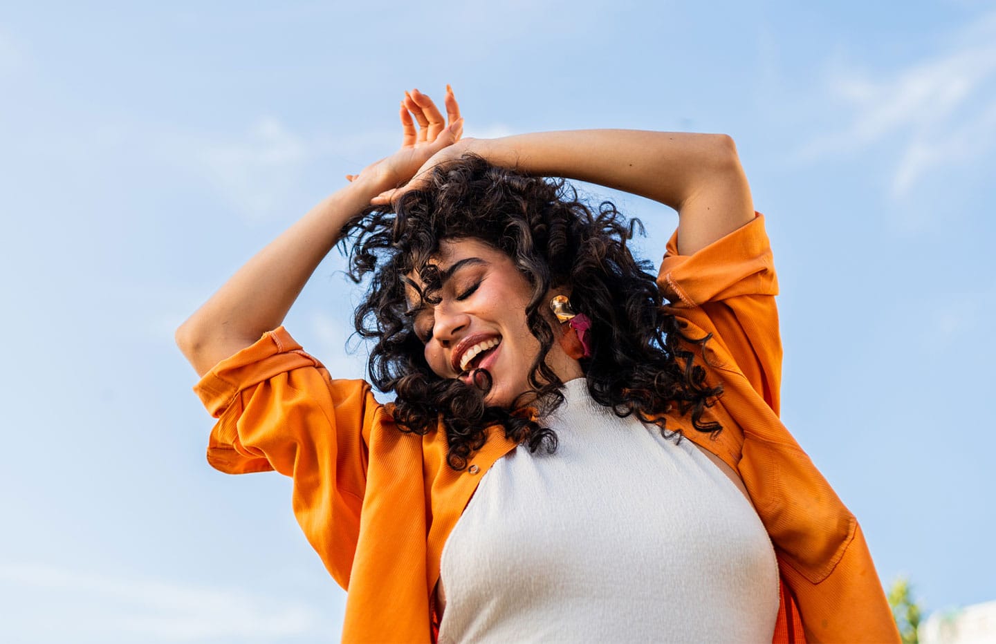 female dancing with her arms above her head