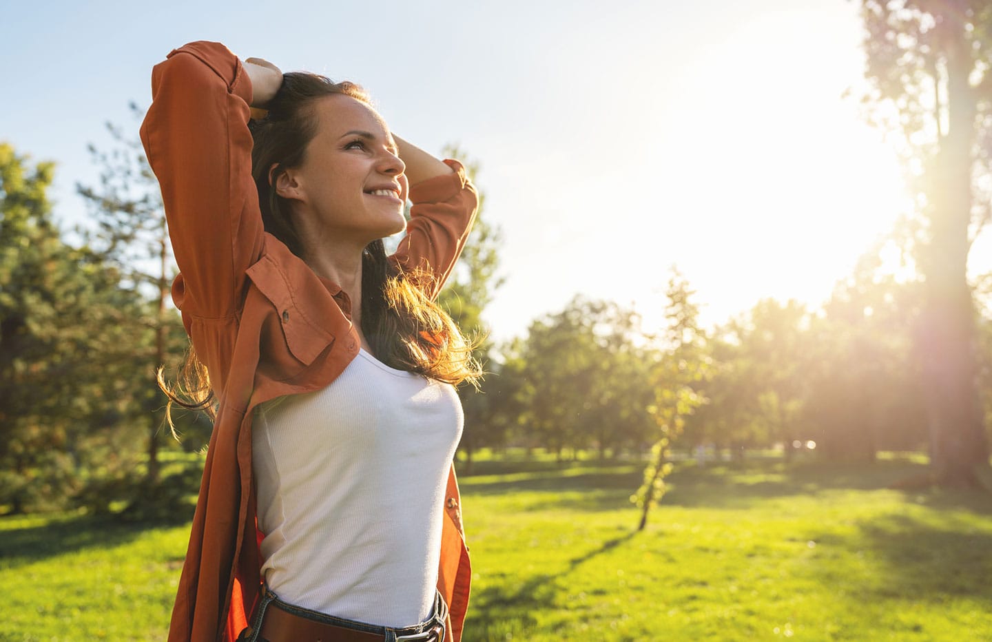 Woman with her hands on her hair smiling