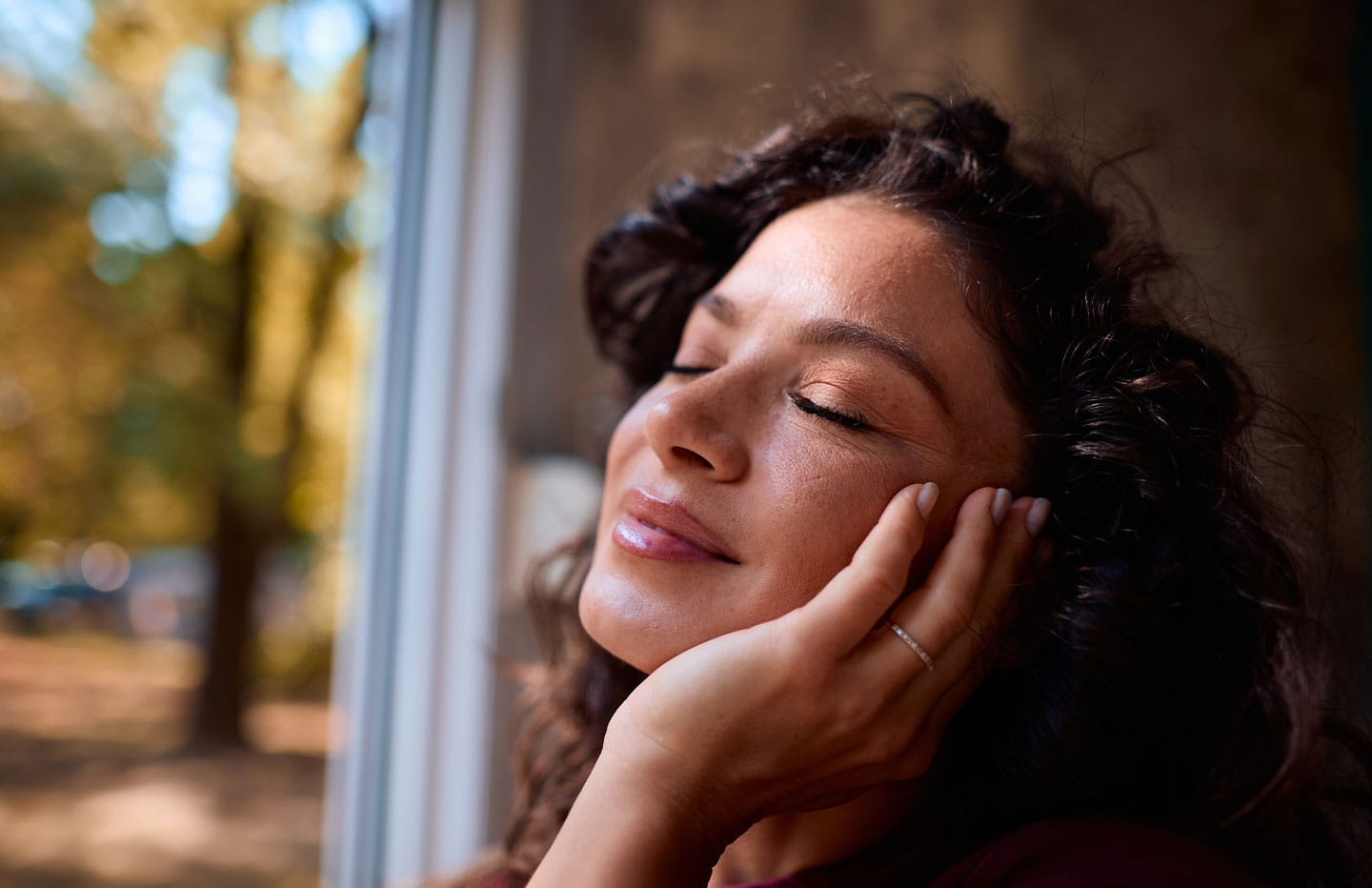 Woman with hand on her face smiling
