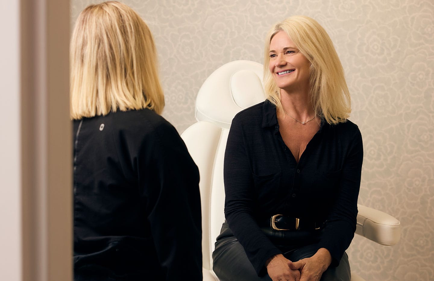 Woman talking to doctor in patient chair